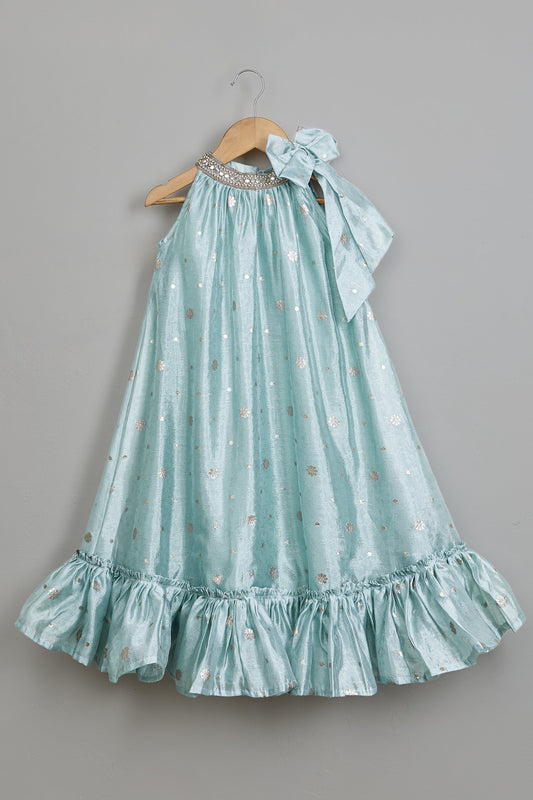 Light blue dress with ruffled hem on a hanger against a gray background.