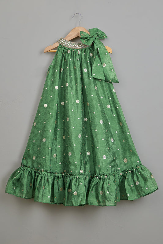 Green dress with bow straps on a gray background