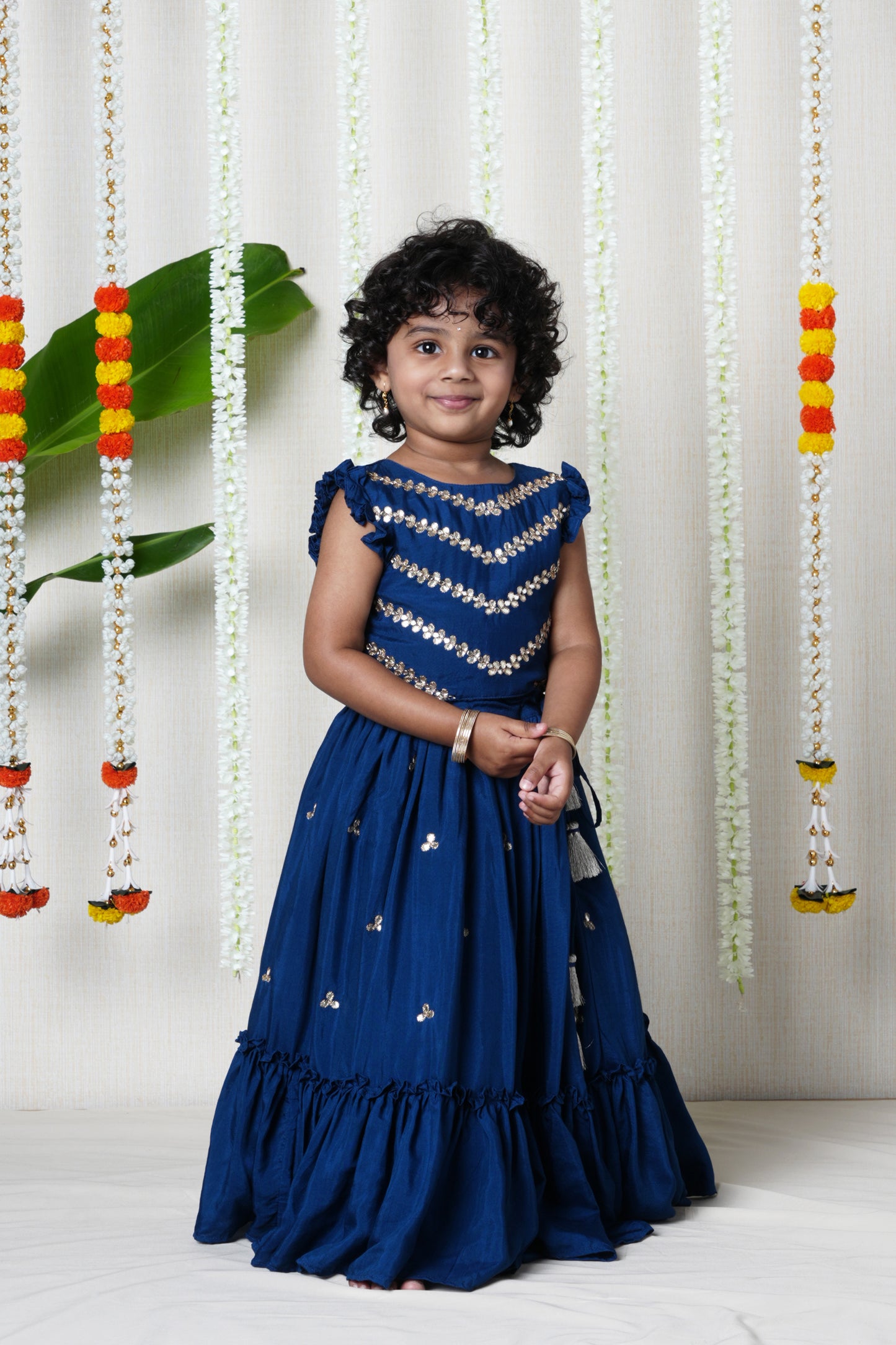 Hand embroidered lehenga and pleated blouse set with shell  enhanced tassels